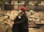 Firefighters battle to control devastating Los Angeles wildfires as ferocious winds calm somewhat