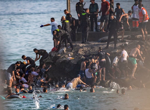 At least 57 people die as tens of thousands cross to Spanish enclave of Ceuta from Morocco